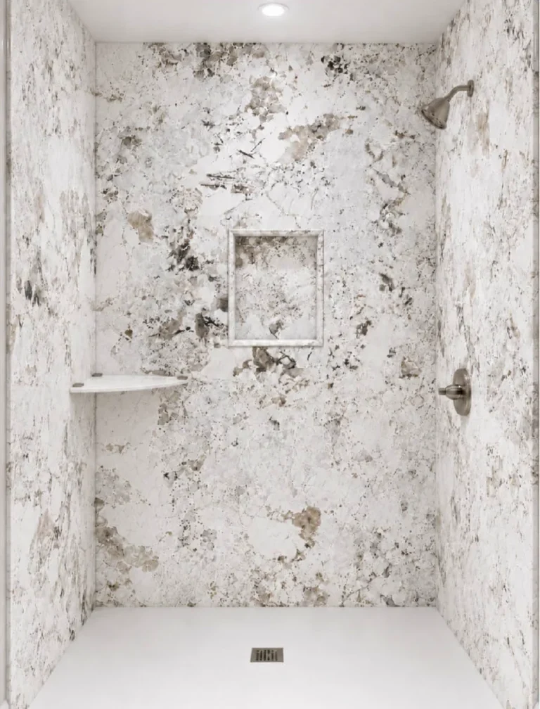 Modern walk-in shower featuring Alaska White porcelain slabs with a white granite-look finish, dramatic gray and beige patterns, a built-in shower niche, and brushed nickel fixtures