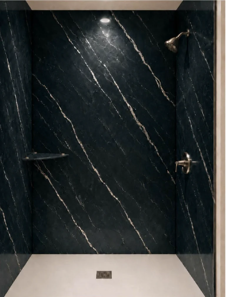 Luxury walk-in shower featuring Black Harmony porcelain slabs with a dramatic black marble-look finish, elegant gold veining, brushed nickel fixtures, and a contrasting white shower base