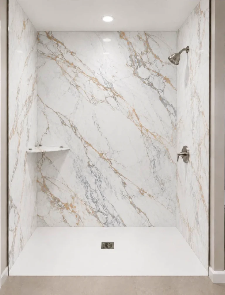 Modern walk-in shower featuring Calacatta Machia porcelain slabs with a white marble-look finish, bold gray and gold veining, and brushed nickel fixtures
