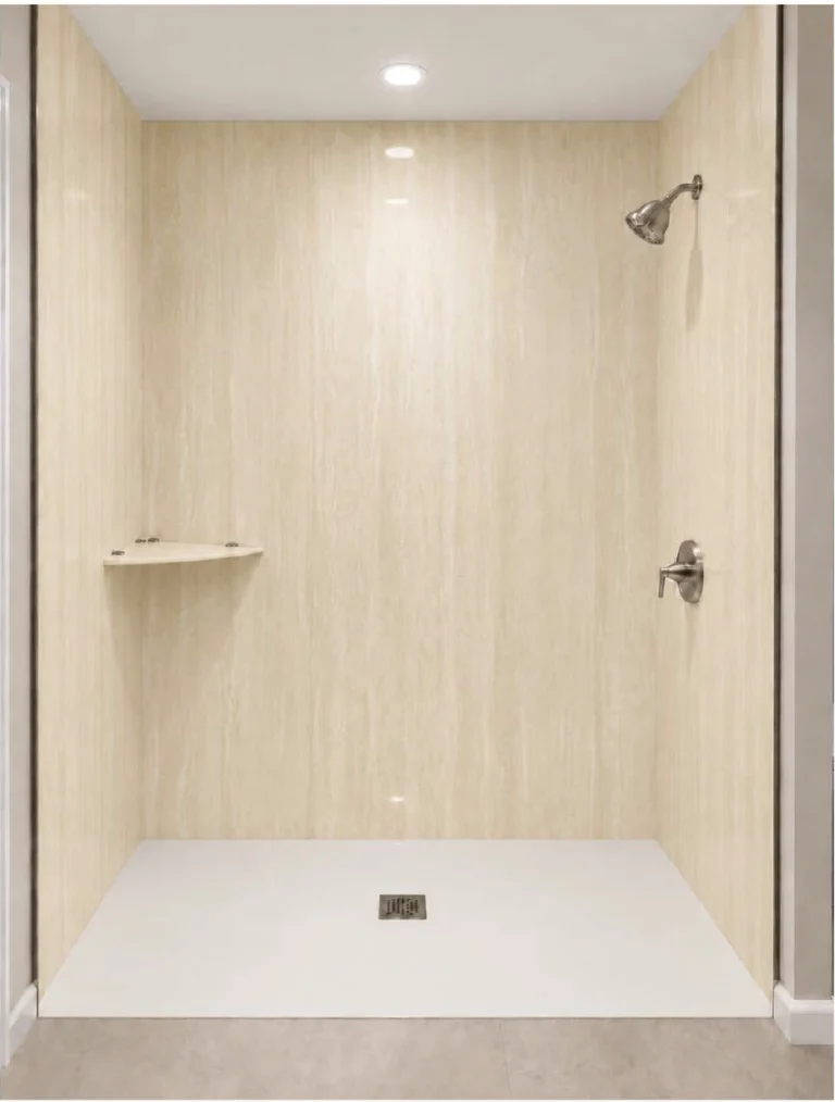 Modern walk-in shower featuring Travertine Ivory porcelain slabs with warm beige tones, subtle linear stone patterns, a white shower base, and brushed nickel fixtures